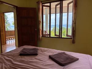 a bedroom with a bed with two towels on it at 2 Bed Sunset Seaview Good View House B in Ko Yao Noi