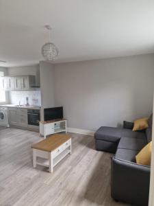 a living room with a couch and a table at The Lodge Ballina in Ballina