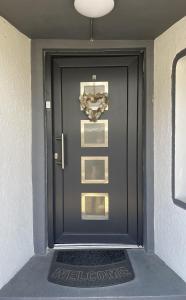 a black door with a picture on it at Apartment Marielena 2 in Püttlingen +3 photos