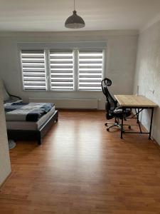 um quarto com uma cama, uma secretária e uma mesa em Apartment Marielena 2 em Püttlingen