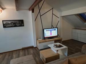 a living room with a television and a couch at Daka in Vrnjačka Banja