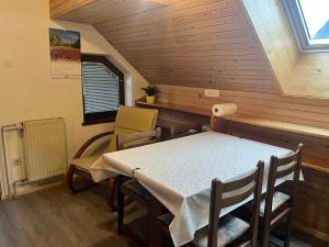 a room with a table and chairs in a cabin at Apartment Cvetek Janez in Bohinj