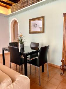 a dining room with a black table and chairs at Laterano Apartment in Rome