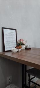 a table with a laptop and a bowl of food on it at 1 комнатная квартира в ЖК Заман возле лётного училища in Aktobe