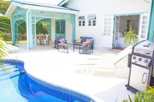 a house with a swimming pool next to a house at Hummingbird in Saint James