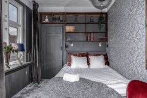 a bedroom with a bed and a book shelf at Cameo Boutique Hotell in Ystad