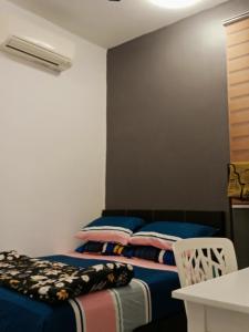 a bedroom with two beds and a table and chairs at MY KIJANG HOMESTAY - Banglo, Alor Setar Kedah DarulAman in Alor Setar