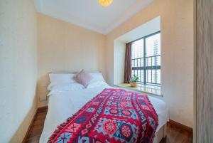 Ένα ή περισσότερα κρεβάτια σε δωμάτιο στο Yue Ke Apartment - Changbin Road Branch