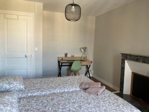 a bedroom with a bed and a desk at L'escale Granvillaise in Granville