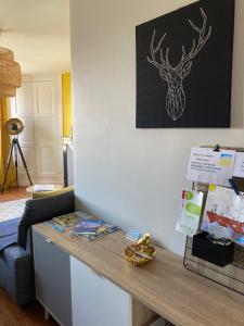 a counter in a room with a picture of a deer on the wall at L'escale Granvillaise in Granville