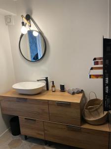 a bathroom with a sink and a mirror on a dresser at Famaméro in Sanary-sur-Mer