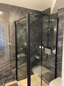 a shower with a glass door in a bathroom at Famaméro in Sanary-sur-Mer