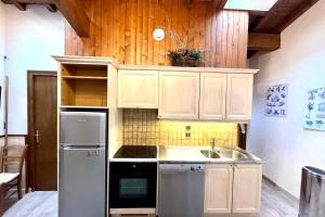 a kitchen with white cabinets and a sink at Nice and bright apartment in Combloux in Combloux