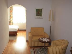 a living room with a chair and a table at Gasthof Post in Frankenmarkt