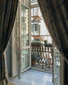 an open window with a view of a balcony at Carafa di Maddaloni By Enjoy Napoli in Naples