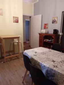 a room with a table and a desk and a table at La Magia Della Collina, Appartement de charme in Turin