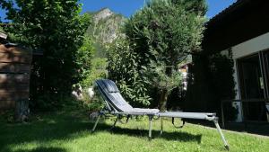 a chair sitting in the grass in a yard at Am Hirschberg in Bad Hindelang