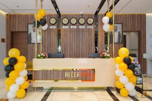 a lobby with yellow and black balloons and a hotel room at AKASIYA HOTEL in Doha