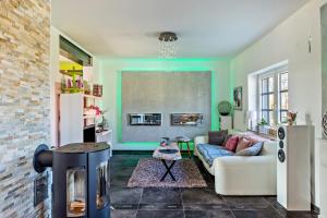 a living room with a couch and a fireplace at La Maisonannette in Vinningen