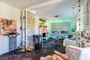 a living room with a couch and a fireplace at La Maisonannette in Vinningen