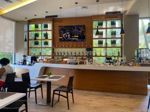 a bar in a restaurant with tables and chairs at Scenic Miami Beach Oasis - Full Kitchen -08A in Hallandale Beach