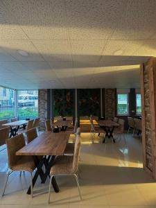 a dining room with wooden tables and chairs at Erbay Mansions Hotel in Trabzon +69 photos