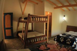 a bedroom with two bunk beds in a room at Alegria Hostel Boutique in Guatapé