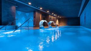 a swimming pool with blue water and slides at Brand New - Massive Studio - E1 - Self Catering in Gibraltar