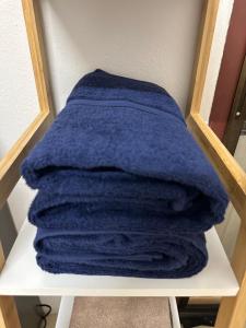 a stack of blue towels sitting on a shelf at The Cozy Garden Chiangmai in Chiang Mai