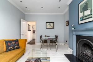 a living room with a couch and a table at 2bed 2bath Victorian maisonette in Barbican in London