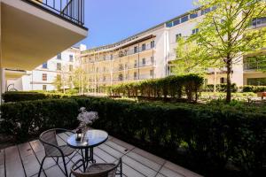 a patio with a table and chairs and a building at Premium Apartments by Wawel Castle in Krakow