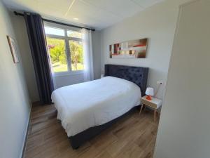 a bedroom with a white bed and a window at B75 Apartments Bilbao in Bilbao