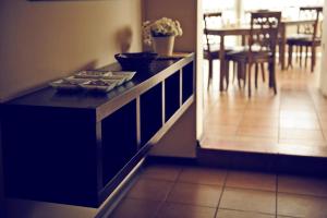 a kitchen with a black counter and a dining room at Üstün Hotel Alsancak in İzmir