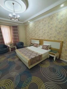 A bed or beds in a room at Astoria Hotel Baku
