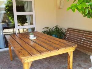 a wooden table sitting next to a wooden bench at Suites on 74 in Worcester