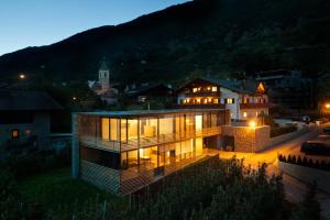 a house is lit up at night at Appartements Kortscherhof in Silandro