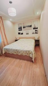 ein Schlafzimmer mit einem großen Bett in einem Zimmer in der Unterkunft Кандавас 9 in Daugavpils