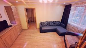 a living room with a couch and a flat screen tv at Кандавас 9 in Daugavpils +9 photos