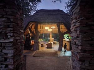 an entrance to a house with a stone wall at Karongwe River Lodge in Karongwe Game Reserve
