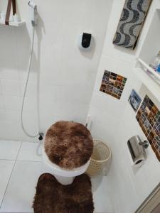 a bathroom with a toilet with a rug on the floor at Apt Flamengo colado metrô praias in Rio de Janeiro