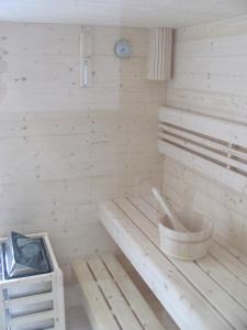 a sauna with a bench and a clock in it at Ferienhäuser Buchenweg in Bodenmais