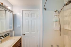 a bathroom with a white door and a sink at Chicago Escape Near Navy Pier and Shedd Aquarium! in Chicago