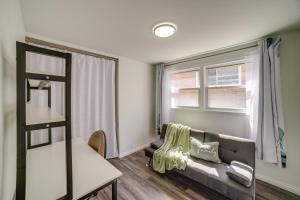 a living room with a couch and a window at Chicago Escape Near Navy Pier and Shedd Aquarium! in Chicago