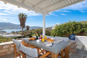 a table with food and a view of the ocean at Olivia's Countryside House in Krotiri