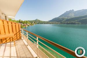 a balcony with a view of a lake at Les Libellules accès direct au lac, 7 apts du studio au 4 ch, LLA Selections by LocationlacAnnecy in Duingt