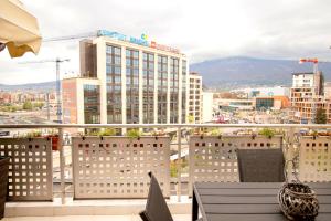 a balcony with a view of a city at Cozy Apartment with Mountain View & Parking in Sofia