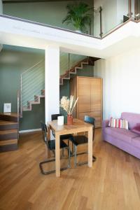 a living room with a table and a purple couch at Coltivare AgriRelais in La Morra +25 photos