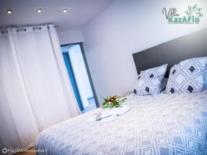 um quarto com uma cama com flores em La villa KazAFlo Piscine, jacuzzi, SPA, brasero em Saint-Joseph