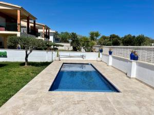 a swimming pool in the backyard of a house at Villa Aeroclub REF. 002 in Castellón de la Plana