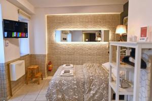 a small room with a bed and a mirror at #Tyrtaiou Modern Design Studio in Mytilene +13 photos